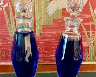 $150 PAIR;  Decorative crystal decanters filled with blue liquid-- tops do not remove. As is, small chips in bases. Each is 12" H x 3" diameter