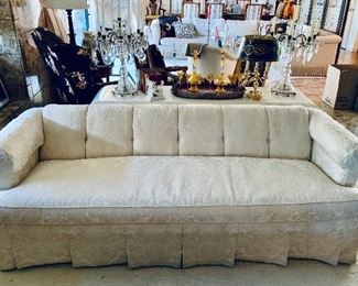 $1800; Pair of ivory  sofas; Rolled arm, heavy damask; single cushion, tufted back and pleated skirt; very good condition; EACH 27" H x 82" L x 28" D, seat height is 18" 