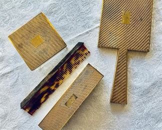 $250; 4-Piece Asprey Vanity Set with Comb, Brush, Hand Mirror, and Jar; mirror is 9" long, jar is 3" square.