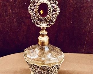 $20; Perfume bottle in metals stand; as is, stopper is slightly dented; 8" H x 3.5" W x 2.5" D 