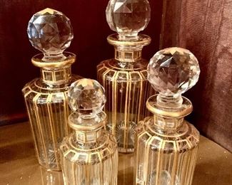$595; Set of 4 gold trimmed crystal dresser jars with stoppers; unsigned, attributed to Baccarat (late 19th century); Largest is 8" H x 3" diameter; 