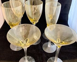 $20 each; Yellow and Clear Glass Stemware with Quatrefoil Stems; 2 Martini glasses (7" H); 3 wine glasses (9.5" H); 2 champagne flutes (10" H) 