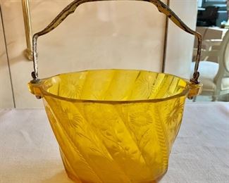 $50 - Yellow glass basket with handle and cut glass flower design; 8.5” x W 9.5” H with handle up