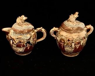 $120; Satsuma Creamer and Sugar Bowl, dragons with handpainted figures; sugar bowl is 5.5" H x 5" W; As is, creamer lid has a break in the dragon on top (missing piece is included)