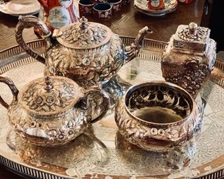 $300; Set of 4 silver-plate repousse  mismatched tea service.  Tea pot and round lidded caddy marked Justis & Armiger, remaining pieces unmarked.  