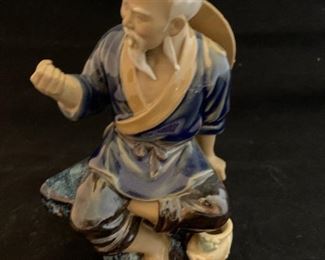 $50; Mud man seated figurine, missing fishing pole; 7" H