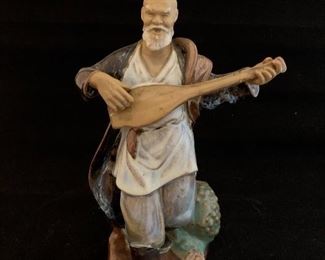 $50; Mud man figurine with instrument; 9"