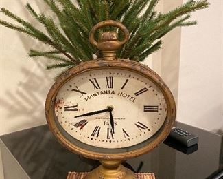 Printania Hotel French Country clock, With Roman numerals, a distressed face and a sturdy rustic finished metal encasement, this French Country inspired table clock is enough to make any Francophile go in search of lost time. Undeniably nostalgic and definitely charming, this time piece also embraces modern convenience, operating on one AA battery