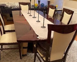 Milano Dining room table, with Sapelli Mahogany Finish  42.5 x 72.5 includes 2 17" extensions, 2 Milano Arm chairs with Sapelli Mahogany Finish and Beige Leather seat and back, and 4 Side chairs