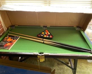 cool pool table with pool cues etc