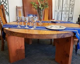 Handcrafted in Taos New Mexico, solid wood table and six chairs the table is 72 inch round 30 inches tall and 3 inches thick held together with iron rods the chairs are sculpted to fit your back. Wonderful set . Now offering $400.00 credit for professional mover to buyer.