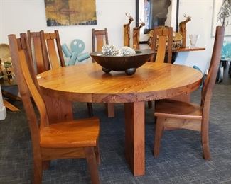 Handcrafted in Taos New Mexico, solid wood table and six chairs the table is 72 inch round 30 inches tall and 3 inches thick held together with iron rods the chairs are sculpted to fit your back. Wonderful set . Now offering $400.00 credit for professional mover to buyer.