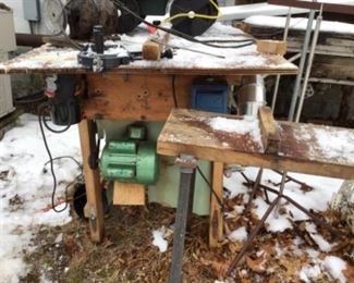 Multi-functional customized table saw in background. It includes a router, sanding disk, vacuum, etc.