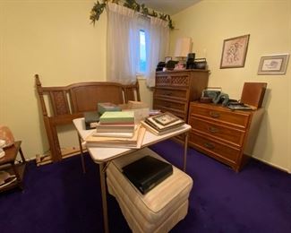 At the left of  second story staircase is the first bedroom, the purple carpet room. Full size MCM Dixie headboard and tall dresser. Vintage photos, slides, films some dating to the 1950's. Artwork, etc