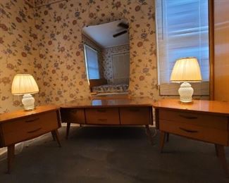 https://ctbids.com/#!/description/share/697645 This German furniture was owned by a family member from Aachen, Germany. All of these pieces are from her home country and they were shipped here. The states that they are at least 40-50 years old. See matching bed: Lot B2101. The end tables are 21" tall, and 21" x 14" wide. The two drawers are 16" x 10" wide and 3" deep. The two lamps stand 15" tall. The dresser with mirror stands 66" tall. Without the mirror it is 21" tall. The two middle drawers are 16" x 14" wide and 3" deep. The two side fold down cabinets are 16" x 14" wide and 8" deep.

