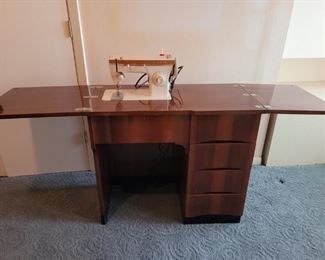 https://ctbids.com/#!/description/share/697644 Singer sewing machine that tucks away for easy storage. It has four drawers to keep all of your sewing needs together. The table is 30" tall. When the top is closed it is 35" x 18" wide. When the top folds out it is 70" x 18" wide.

