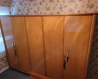 https://ctbids.com/#!/description/share/697647 This German furniture was owned by a family member from Aachen, Germany. All of these pieces are from her home country and they were shipped here. The client states that they are at least 40-50 years old. See the other two matching lots B2100 and B2101. This piece in total is 102" wide, 23" deep and 71" tall. There are three individual locking cabinets. The two on the sides are 65" tall, 38" wide and 20" deep. There is a hanging rack and a 12" deep shelf in both. The middle cabinet is just 18" wide. But it has a 19" deep shelf. This is truly a unique Armoire in beautiful condition!

