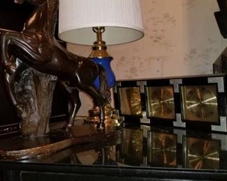 https://ctbids.com/#!/description/share/697652 Decorate your favorite corner in the house. Includes table, wooden horse, barometer and a beautiful brass and cobalt blue lamp. End table 28"square x 20" h. Carved wooden horse. 20" h x 19"w. Barometer 21" h x 8"w x 3"d. Lamp 29" h x 12"w.

