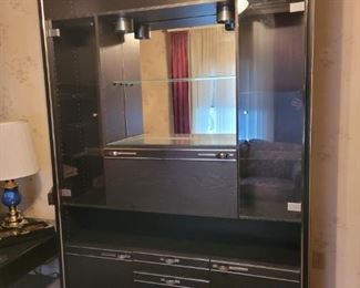 https://ctbids.com/#!/description/share/697656 This is a nice wood veneer media center/bar with a black finish. Cabinet features a lot of storage areas for your items. There is one fold down cabinet, two small bottom cabinets, three drawers and adjustable glass display shelves. Its 86" high, 61" wide and 14" deep and appears to be 1 piece.

