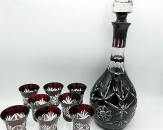 https://ctbids.com/#!/description/share/697688 This is a beautiful red cut crystal decanter set with 8 aperitif glasses. The decanter measures 16" tall, the glasses measure 5" tall. There is a small chip on one of the glasses (shown in photo).

