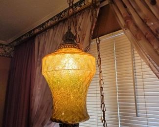https://ctbids.com/#!/description/share/697693 This is a very unique hanging light with brass and gold detail. 21" tall and 11" across in the widest area.

