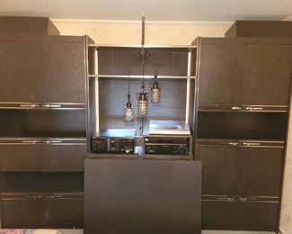 https://ctbids.com/#!/description/share/697665 This piece does not include the middle shelf, pendant lights or speakers. It consists of two side cabinets that are both 86" tall and each 41" across. There are two open shelves connecting them on top that are 45" across. The unit from the wall is 13" deep.

