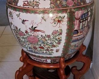 Very large Asian pot on wooden stand.