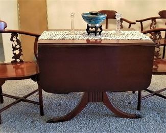 Antique table that folds down on both sides. Just beautiful! There are 4 rosewood Oriental Corner Chairs Hand Carved Back Supports.