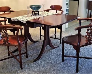 View of dining table with sides up. Antique table that folds down on both sides. Just beautiful! There are 4 rosewood Oriental Corner Chairs Hand Carved Back Supports