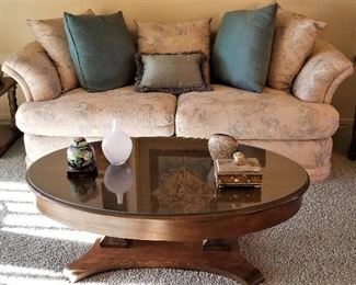 Oval coffee table and like new sofa.