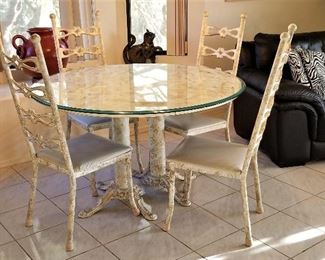 Beige metal dining chairs and round table for kitchen or dining area.