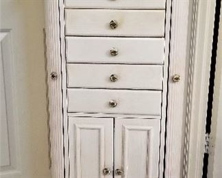 Creamy white jewelry armoire. Sides open, top opens along with bottom cabinet.