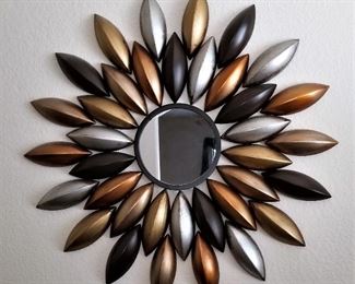 Gold and silver and black metal sunburst mirror.