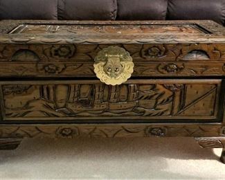 Small carved wood trunk great for in front of a loveseat or at the end of a bed or in a hallway or entryway.