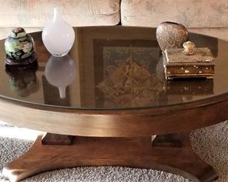 Exquisite wooden oval coffee table with glass top. 