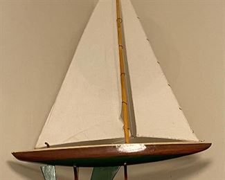 Handmade wooden sailboat on stand