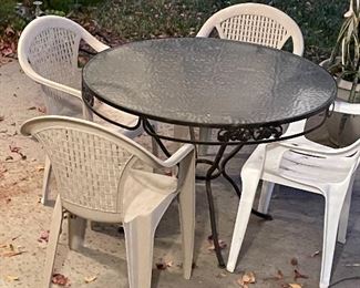 Iron & glass patio table & 4 plastic chairs...
