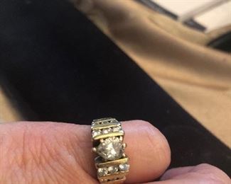 14 k diamond wedding ring pear center stone  round side stones  nit sure of carat  we can take it to a jeweler for closer inspection $975