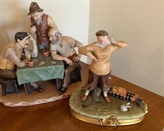 Two fun ceramic figurines. Three men playing a jovial game of cards measures 10" x 9" and the golfer with the "rabbit in the hole" measures 8" x 9"