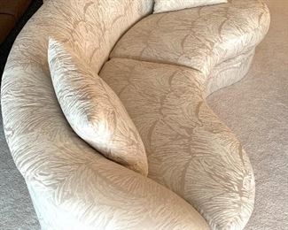 Luxurious Curved Sofa by Directional. Beautifully upholstered sofa in an ivory print fabric in very good condition. Measuring 76" L x 35" W x 27" H. There are two of these sofas available in this auction.