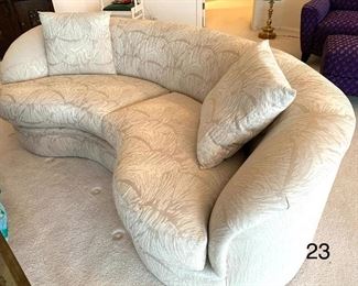 Luxurious Curved Sofa by Directional. Beautifully upholstered sofa in an ivory print fabric in very good condition. Measuring 76" L x 35" W x 27" H. There are two of these sofas available in this auction.