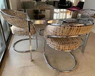 Mid Century Chrome/Glass Dining Table and Cantilever Chairs. Amazing glass top/chrome base table that expands - leaves are underneath. Four wonderful cantilever chrome base chairs. Table when closed is 42" x 42" x 28" and when opened, it adds an additional 36" 