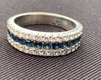 14k White gold and sapphire channel set ring. Marked ADPG inside and 14k. Weight is 5.83 grams.
