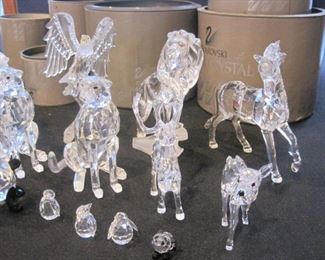 Table full of Swarovski Crystal Figurines.