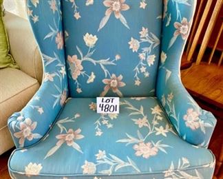 Lot 4801. $150.00   Wing back chair with Queen Ann legs.  Upholstered in a blue floral with neutral cream colored fabric on the sides and back.  31" W x 44" H x 19" seat depth	