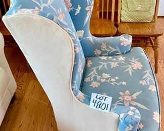 Lot 4801. $150.00   Wing back chair with Queen Ann legs.  Upholstered in a blue floral with neutral cream colored fabric on the sides and back.  31" W x 44" H x 19" seat depth	