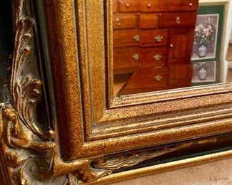 Lot 4822.  $425.00   Beautiful, Ginormous embellished, beveled mirror in perfect condition.  The frame is in antique gold and black.	46" H x 70" L. Super well-crafted - we would presume it's quite heavy.  We were afraid to remove it from the wall at this point due to the size and weight.  This would be an ideal piece to help make a room look larger than it is.  