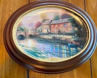 Lot 4842. $45.00 Set of 3 Thomas Kinkade framed oval collector plates 11.5" with wood frame and 9.25" plate alone.  From the Lamplight Village Collection - 1) Lamplight Brooke, 2) Lamplight Lane, 3) Lamplight Inn with Vanhygan & Smythe frames.