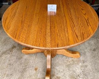 Lot 4862  $150.00  Classic Round Amish Style Oak Dining Table, 42"diameter, plus one 12" leaf with pedestal base!  LOTS OF POTENTIAL! Matches the previous lot of 6 Oak Dining Chairs