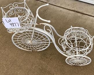 Lot 4877   $52.00  Gardeners Lot,  Cute thin metal Bunny, Wrought Iron Garden Trike planter with 2 baskets , and a metal plant stand/table.. Measurements:  Rabbit: 16" H; Tricycle 21" H x 27" L, Plant  stand: 12" W.
